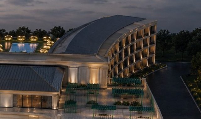 Aerial night view of the Legacy Residences above the pool court