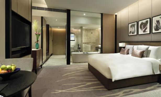 A Legacy King room with lounge seating, king bed and spa bathroom